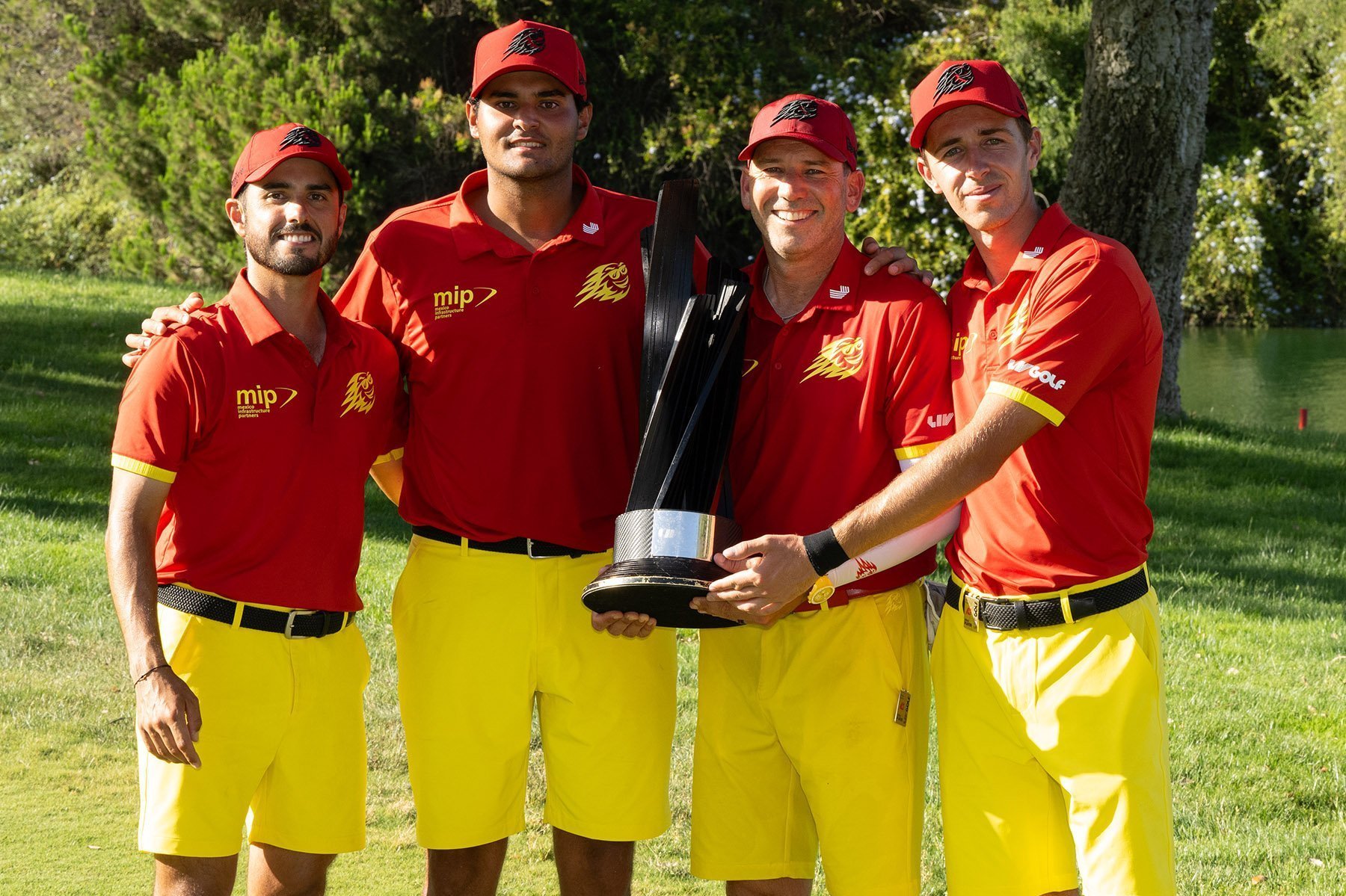 Abraham Ancer, Sergio Garcia, David Puig, and Eugenio Chacarra of Fireballs GC celebrate on stage at LIV Golf Andalucía 2024.